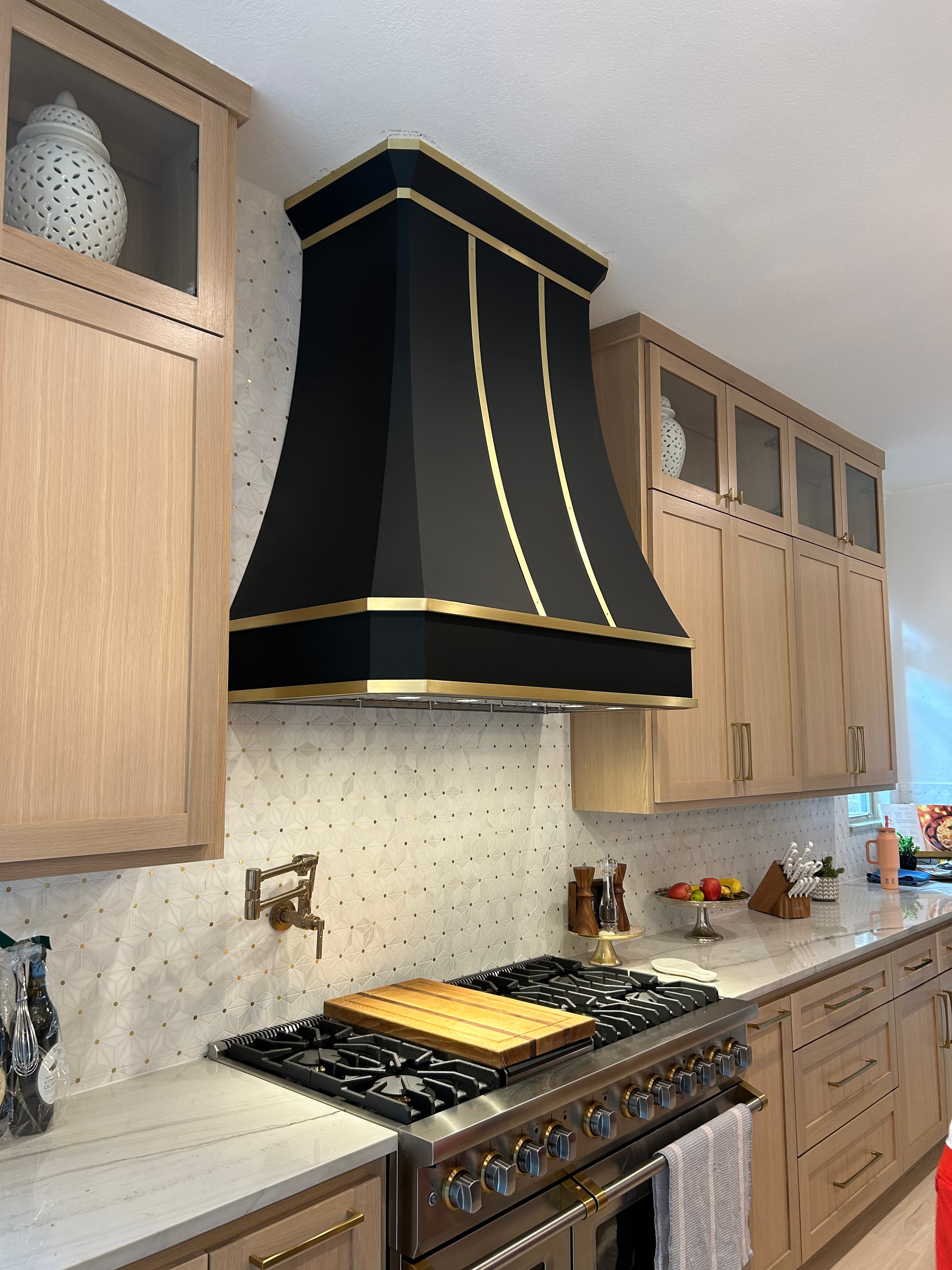 A collection of custom Monarch range hoods installed in client kitchens